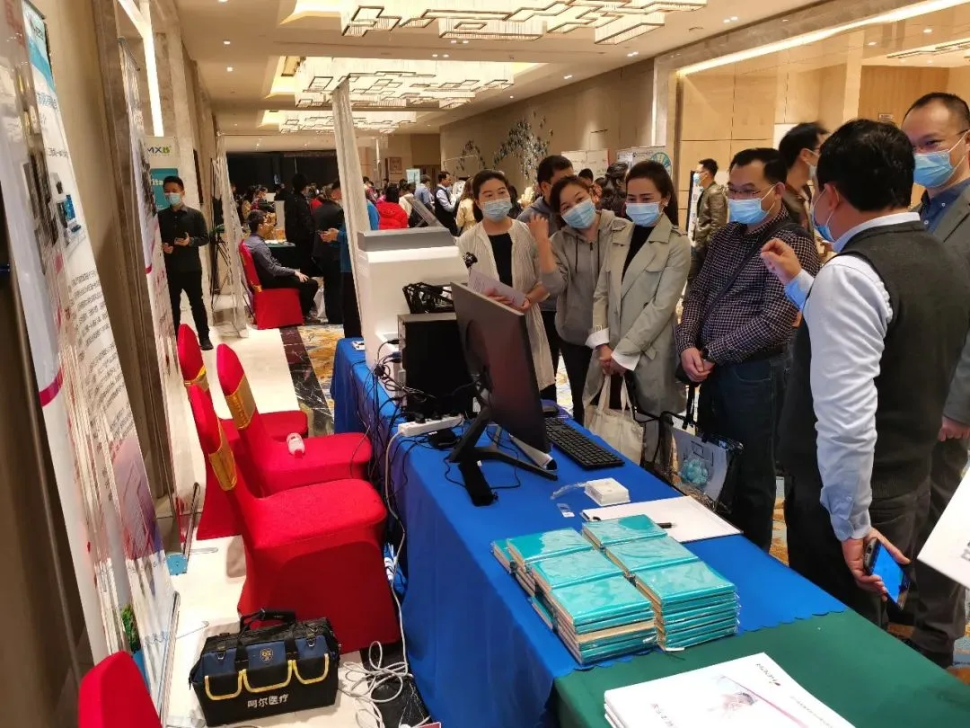 Experts learn about the device at the booth